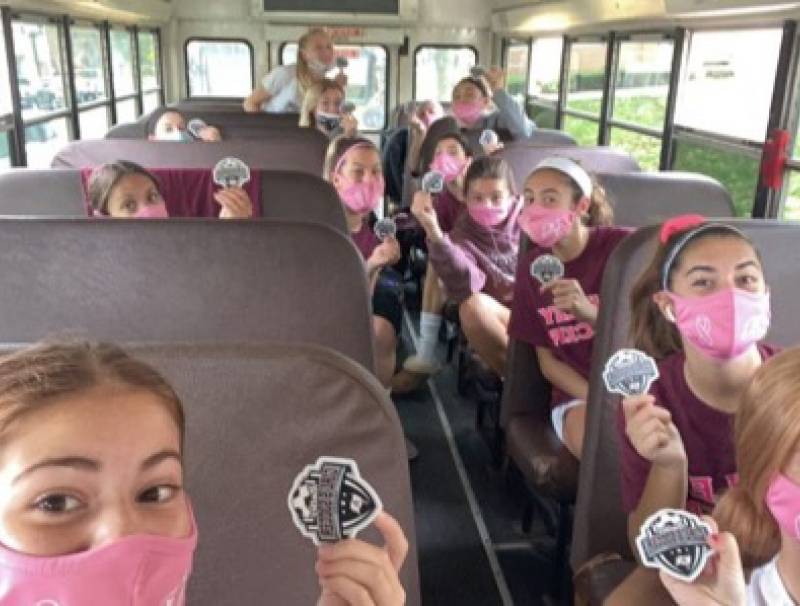 The girls on the way to their game all masked up!