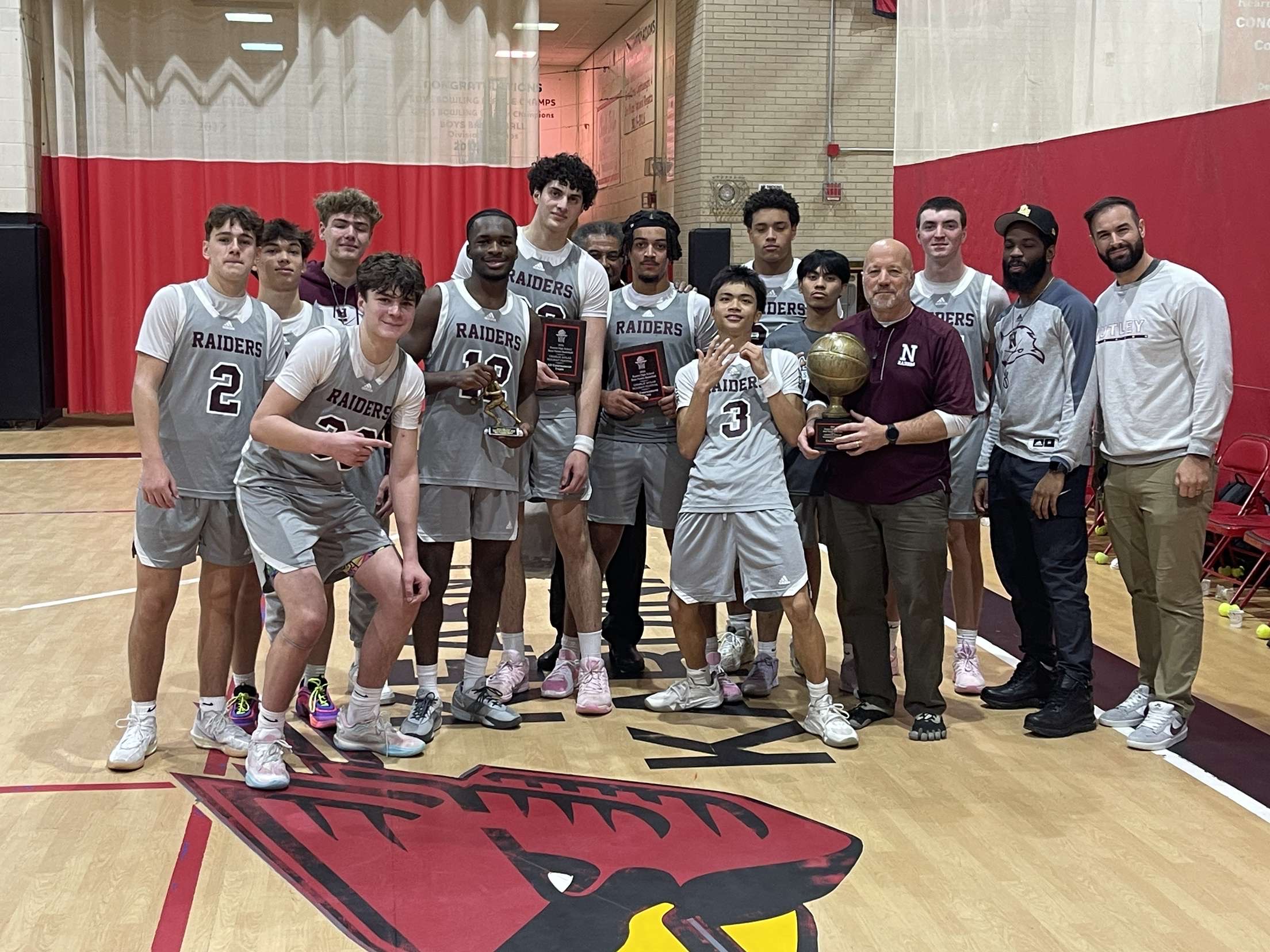 Raiders hoisting trophy after winning Kearny Christmas tournament