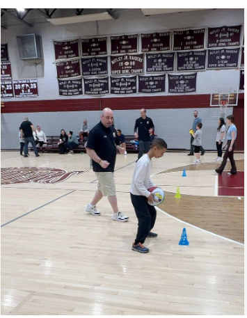 Mike Simmel Helps Child Dribble BasketBall