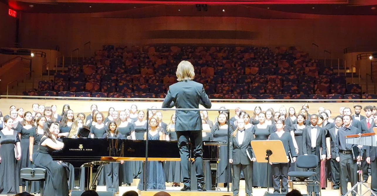 Eric Whitacre conducting a group of high school choir students in Lincoln Center, including Nutley High School students