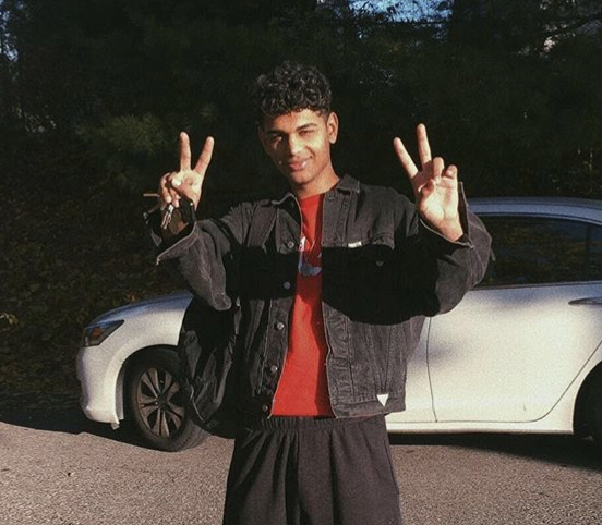 Ahmed wearing a denim jacket along with a red teeshirt