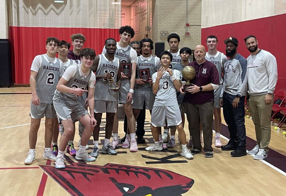 Raiders hoisting trophy after winning Kearny Christmas tournament