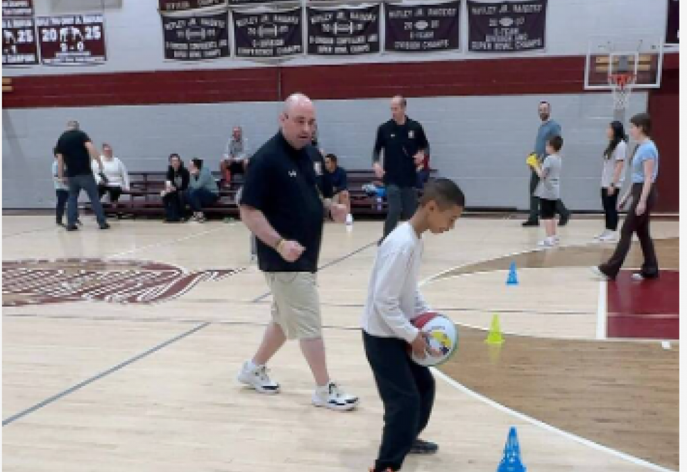Mike Simmel Helps Child Dribble BasketBall