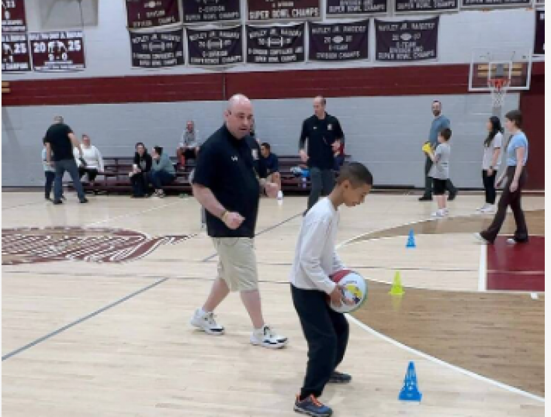 Mike Simmel Helps Child Dribble BasketBall