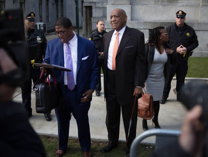 Bill Cosby and his attorney leaving his sexual assault case