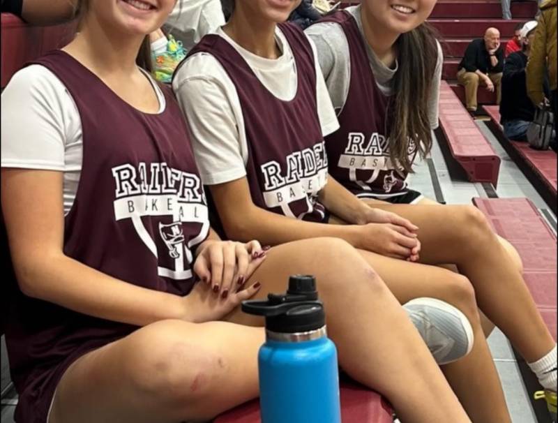 Valdez and friends, seated in basketball uniforms
