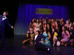 Cast Members pose for on stage picture