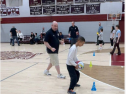 Mike Simmel Helps Child Dribble BasketBall